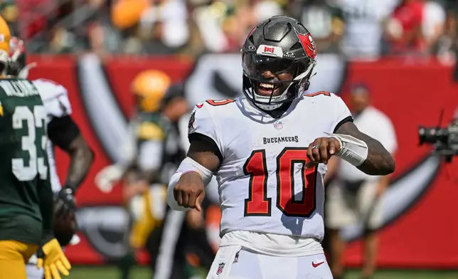 Tampa Bay Buccaneers quarterback Jalon Daniels (10) celebrates a second half touchdown during an NFL football game against the Green Bay Packers in Tampa, Fla., Sunday, Oct. 4, 2026. (AP Photo/Jason Behnken)