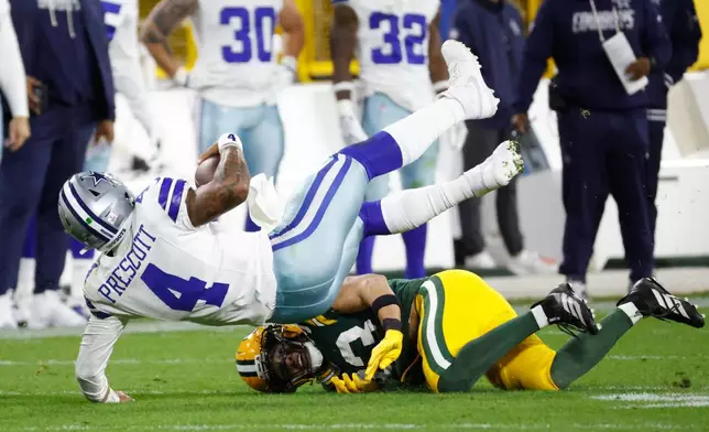 Green Bay Packers' Evan Williams stops Dallas Cowboys' Dak Prescott during the second half of an NFL football game in Green Bay, Wis., Sunday, Oct. 18, 2026. (AP Photo/Mike Roemer)