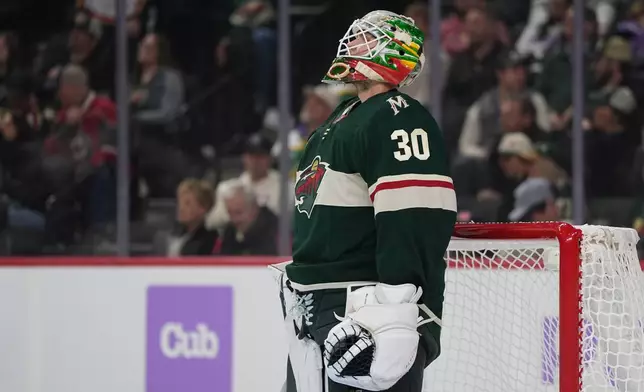 Minnesota Wild goaltender Jesper Wallstedt looks at the replay board after a goal by Columbus Blue Jackets center Adam Fantilli during the first period of an NHL hockey game, Sunday, Oct. 18, 2026, in St. Paul, Minn. (AP Photo/Abbie Parr)