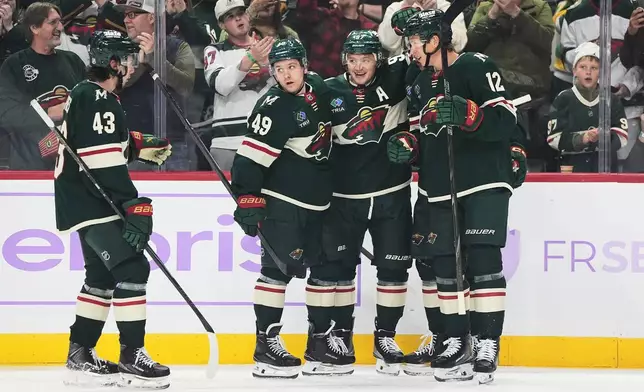 Minnesota Wild left wing Kirill Kaprizov (97) celebrates with teammates after scoring during the second period of an NHL hockey game against the Columbus Blue Jackets, Sunday, Oct. 18, 2026, in St. Paul, Minn. (AP Photo/Abbie Parr)