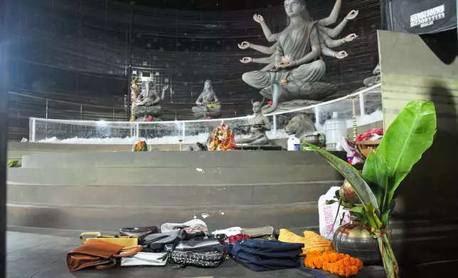 Purses and other belongings left behind by devotees lie on the floor of a worship venue for the Hindu festival of Durga Puja following a stampede, in Kolkata, India, Saturday, Oct. 17, 2026. (AP Photo)