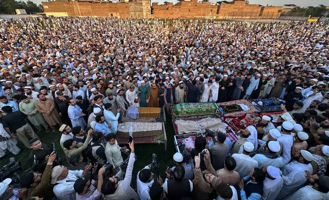 Mourners attend funeral prayers of children who died from a roof collapsing at a private school, in Peshawar, Pakistan, Pakistan, Thursday, Oct. 15, 2026. (AP Photo/Maaz Awan)