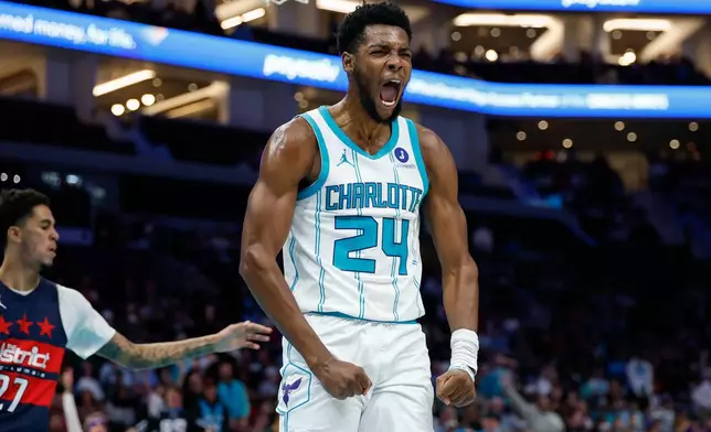 Charlotte Hornets forward Brandon Miller reacts after dunking against the Washington Wizards during the first half of an NBA basketball game in Charlotte, N.C., Monday, Oct. 26, 2026. (AP Photo/Nell Redmond)