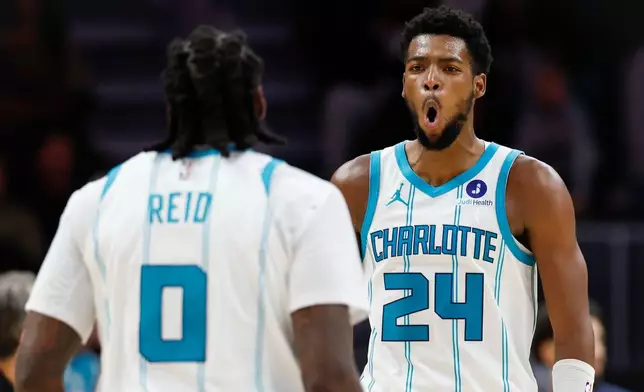 Charlotte Hornets forward Brandon Miller (24) reacts after center Naz Reid (0) made a 3-point basket during the second half of an NBA basketball game against the Washington Wizards in Charlotte, N.C., Monday, Oct. 26, 2026. (AP Photo/Nell Redmond)