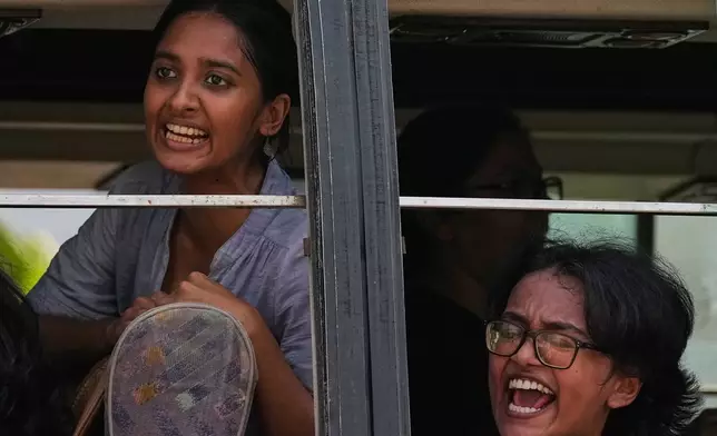 Detained youth protesters shout slogans as police drive them away in a van from a demonstration by the Cockroach Janta Party demanding the resignation of Chief Election Commissioner Gyanesh Kumar in New Delhi, India, Saturday, Oct. 10, 2026. (AP Photo/Manish Swarup)