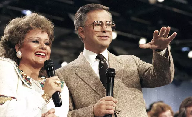 FILE -FILE - Jim And Tammy Faye Bakker talk to their television audience, Aug. 20, 1986 at their PTL Ministry in Fort Mill, S.C. (AP Photo/Lou Krasky, File)