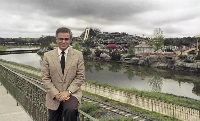 FILE - Television evangelist Jim Bakker poses in front of the Water Park in Columbia, SC, one of the attractions at his Heritage USA, March 19, 1987. (AP Photo/Lou Krasky, File)
