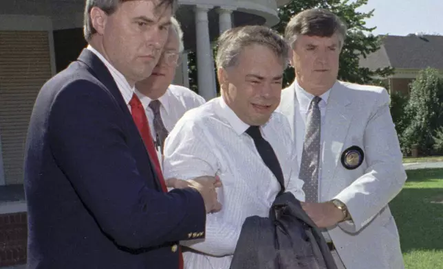 FILE -FILE - U.S. marshals escort former PTL leader Jim Bakker, center, from his attorney's office to a waiting car Thursday afternoon Aug. 31, 1989 in Charlotte, N.C. (AP Photo/Chuck Burton, File)