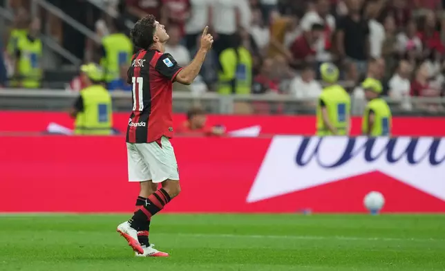 AC Milan's Christian Pulisic celebrates after scoring his side's opening goal during the Serie A soccer match between AC Milan and Lecce, in Milan, Italy, Sunday, Sept. 20, 2026. (AP Photo/Antonio Calanni)