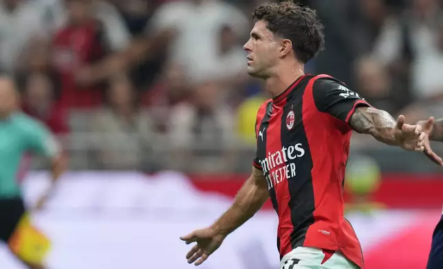 AC Milan's Christian Pulisic celebrates after scoring his side's opening goal during the Serie A soccer match between AC Milan and Lecce, in Milan, Italy, Sunday, Sept. 20, 2026. (AP Photo/Antonio Calanni)