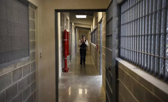 A police officer walks through a hallway during a press tour of a new high-security prison in Alajuela, Costa Rica, Wednesday, Oct. 14, 2026. (AP Photo/Jose Diaz)