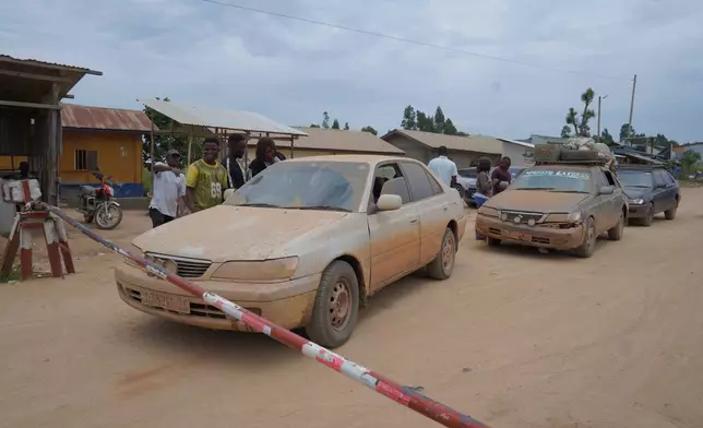 Cars are stopped at the Tchai checkpoint, set up to contain the spread of Ebola virus, between Ituri and North Kivu provinces, in Congo, Friday, Oct. 23, 2026. (AP Photo/Dieudonne Dirole)