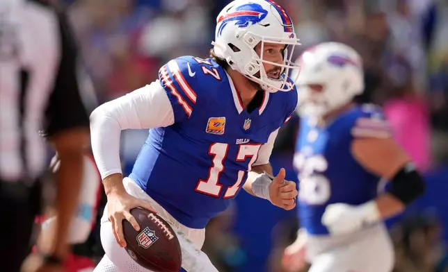 Buffalo Bills quarterback Josh Allen (17) celebrates after scoring a touchdown against the New England Patriots in the first half during an NFL football game in Orchard Park, N.Y., Sunday, Oct. 4, 2026. (AP Photo/Carolyn Kaster)