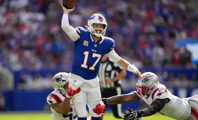 Buffalo Bills quarterback Josh Allen (17) passes against New England Patriots center Jared Wilson (55) and defensive end Dre'mont Jones (5) during an NFL football game in Orchard Park, N.Y., Sunday, Oct. 4, 2026. (AP Photo/Carolyn Kaster)