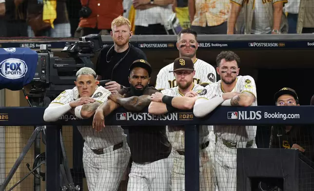 San Diego Padres players watch from the dugout during the ninth inning in Game 4 of baseball's National League Division Series against the Milwaukee Brewers Wednesday, Oct. 7, 2026, in San Diego. (AP Photo/Derrick Tuskan)