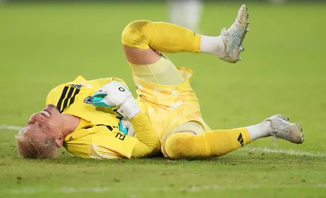 Vancouver Whitecaps goalkeeper Yohei Takaoka grimaces during the second half of an MLS soccer match against St. Louis City Wednesday, Oct. 14, 2026, in St. Louis. (AP Photo/Jeff Roberson)
