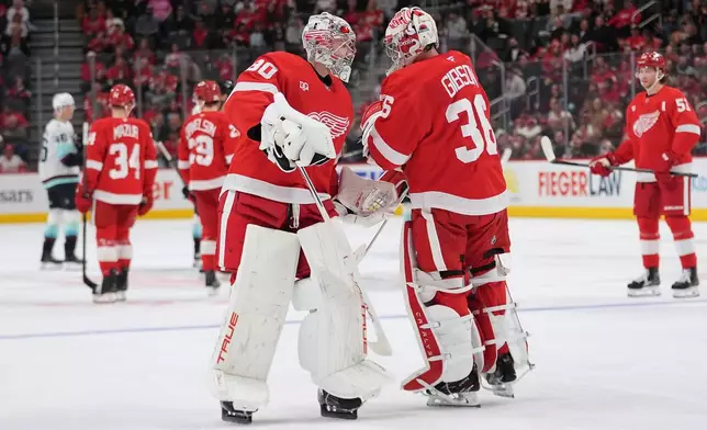 Detroit Red Wings goaltender Daniil Tarasov (80) replaces John Gibson (36) against the Seattle Kraken in the second period of an NHL hockey game Friday, Oct. 9, 2026, in Detroit. (AP Photo/Paul Sancya)