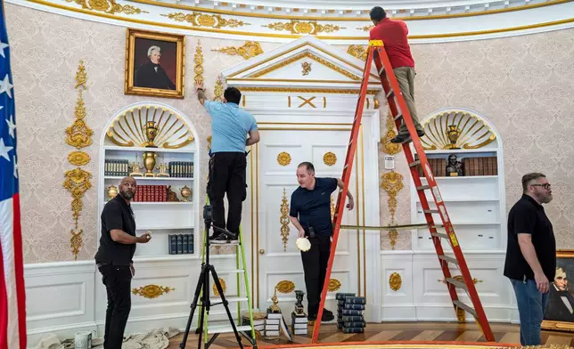 A replica of President Donald Trump's Oval Office is updated to the current decor by workers at "The People's House: A White House Experience," in Washington, Friday, Oct. 2, 2026. (AP Photo/J. Scott Applewhite)
