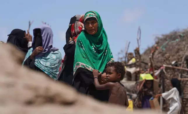 Displaced Yemeni women wait to receive aid supplies at the Al-Salam camp in Dar Saad district, Aden, Yemen, Tuesday, Oct. 6, 2026. (AP Photo/Abdulnasser Alseddik)