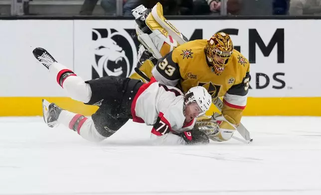Vegas Golden Knights goaltender Adin Hill (33) drives into Ottawa Senators center Ridly Greig (71) during the second period of an NHL hockey game Tuesday, Oct. 27, 2026, in Las Vegas. (AP Photo/John Locher)
