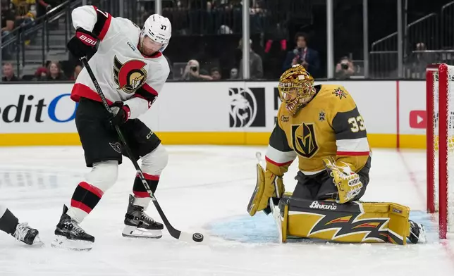 Ottawa Senators left wing Warren Foegele (37) attempts to tip the puck past Vegas Golden Knights goaltender Adin Hill (33) during the third period of an NHL hockey game Tuesday, Oct. 27, 2026, in Las Vegas. (AP Photo/John Locher)
