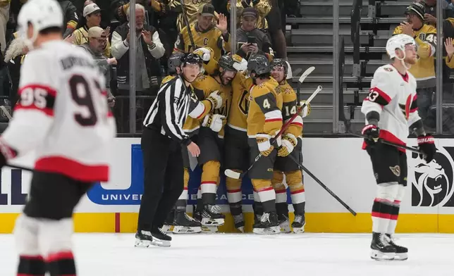 Vegas Golden Knights center Raphael Lavoie, center, celebrates after scoring against the Ottawa Senators during the third period of an NHL hockey game Tuesday, Oct. 27, 2026, in Las Vegas. (AP Photo/John Locher)
