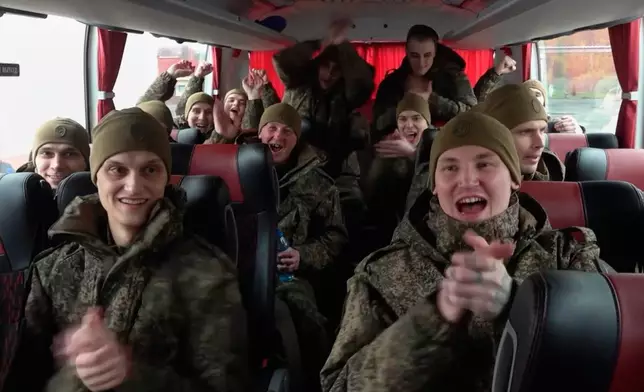 In this image taken from video provided by Russian Defense Ministry Press Service, Russian servicemen sit in a bus after returning from captivity during a POW exchange between Russia and Ukraine, in Belarus, Friday, Oct. 23, 2026. (Russian Defense Ministry Press Service via AP)