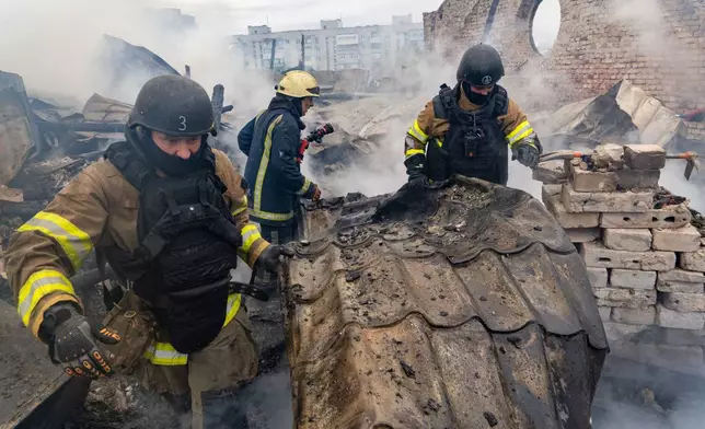 Rescuers work on the roof of the damaged building following Russia's air attack in Kharkiv, Ukraine, Friday, Oct. 23, 2026. (AP Photo/Andrii Marienko)