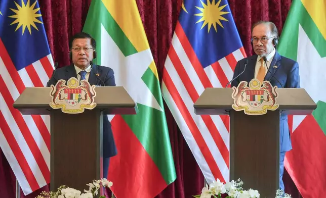 Myanmar's President Min Aung Hlaing, left, speaks as Malaysia's Prime Minister Anwar Ibrahim listens during a joint press conference following their meeting in Putrajaya, Malaysia, Thursday, Oct. 8, 2026. (AP Photo/Azneal Ishak, Pool)