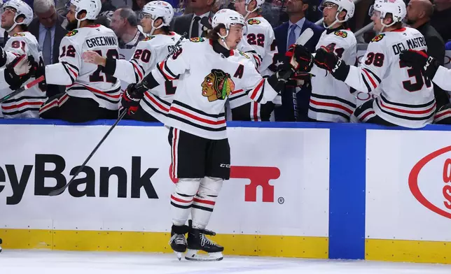 Chicago Blackhawks left wing Tyler Bertuzzi, center, celebrates after his goal during the first period of an NHL hockey game against the Buffalo Sabres, Saturday, Oct. 3, 2026, in Buffalo, N.Y. (AP Photo/Jeffrey T. Barnes)