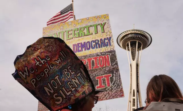 Marchers arrive near the Space Needle during a "No Kings" rally encouraging early voting in Seattle, Saturday, Oct. 17, 2026. (AP Photo/Lindsey Wasson)