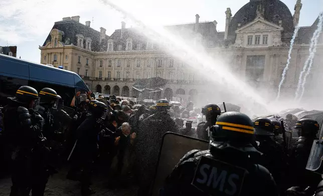 Riot police use a water cannon as they face students during a protest against under-resourced schools, in Rennes, western France, Tuesday, Oct. 6, 2026. (AP Photo/Jeremias Gonzalez)