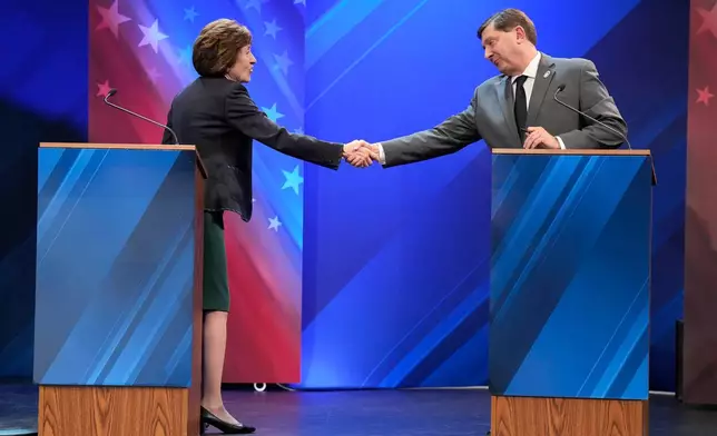 Sen. Susan Collins (R) and Troy Jackson (D) shake hands at the end of the final Maine U.S. Senate debate in Bangor, Maine, Thursday, Oct. 15, 2026. (Gregory A. Rec/Portland Press Herald via AP, Pool)