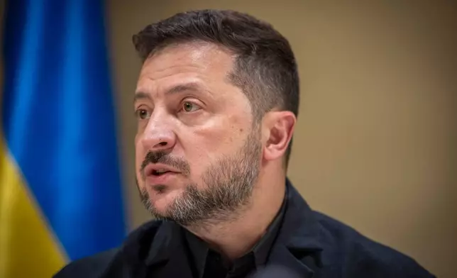 Ukrainian President Volodymyr Zelenskyy speaks to the media after a German-Ukrainian business forum in Kyiv, Ukraine, Sunday, Oct. 4, 2026. (AP Photo/Dan Bashakov)