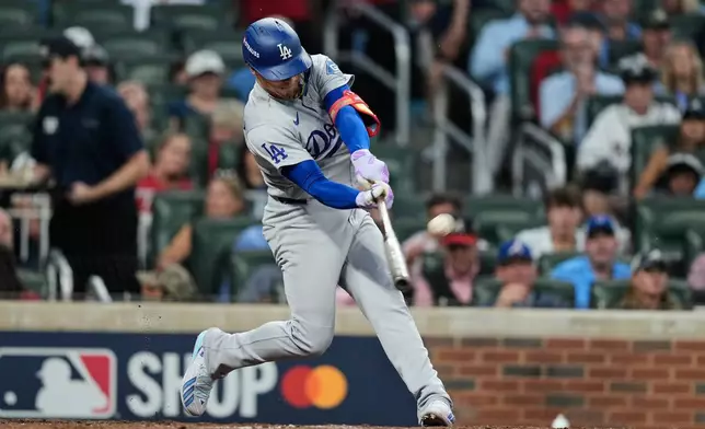 Los Angeles Dodgers' Enrique Hernández connects for a two-run home run during the fourth inning in Game 3 of baseball's National League Division Series against the Atlanta Braves, Tuesday, Oct. 6, 2026, in Atlanta. (AP Photo/Brynn Anderson)