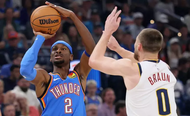 Oklahoma City Thunder guard Shai Gilgeous-Alexander (2) looks to shoot against Denver Nuggets guard Christian Braun (0) during the first half of an NBA basketball game Thursday, Oct. 22, 2026, in Oklahoma City. (AP Photo/Nate Billings)