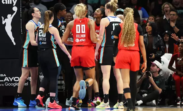 Atlanta Dream forward Angel Reese, center right, exchanges words with New York Liberty center Jonquel Jones, third from left, during the first half of Game 3 of the WNBA basketball semifinals, Friday, Oct. 9, 2026, in New York. (AP Photo/Heather Khalifa)
