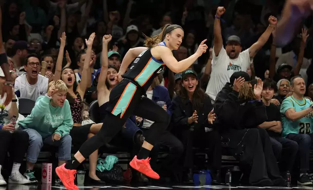 New York Liberty guard Sabrina Ionescu gestures after scoring a 3-point basket during the first half of Game 3 of the WNBA basketball semifinals against the Atlanta Dream, Friday, Oct. 9, 2026, in New York. (AP Photo/Heather Khalifa)