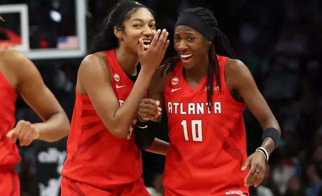 Atlanta Dream forward Angel Reese (5) and Atlanta Dream guard Rhyne Howard (10) react after their team defeated the New York Liberty in Game 3 of the WNBA basketball semifinals, Friday, Oct. 9, 2026, in New York. (AP Photo/Heather Khalifa)