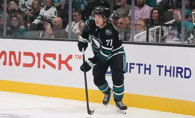 San Jose Sharks center Macklin Celebrini (71) skates with the puck against the Los Angeles Kings during the first period of an NHL hockey game, Saturday, Oct. 3, 2026, San Jose, Calif. (AP Photo/Jeff Chiu)