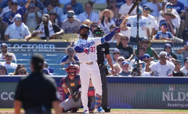 Los Angeles Dodgers' Teoscar Hernández watches his two-run home run during the fourth inning of Game 1 of a National League Division Series baseball game against the Atlanta Braves Saturday, Oct. 3, 2026, in Los Angeles. (AP Photo/Jae C. Hong)