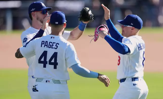 Los Angeles Dodgers left fielder Kiké Hernández, right, celebrates with center fielder Andy Pages (44) and right fielder Kyle Tucker after the Dodgers defeated the Atlanta Braves 5-3 in Game 1 of a National League Division Series baseball game Saturday, Oct. 3, 2026, in Los Angeles. (AP Photo/Jae C. Hong)