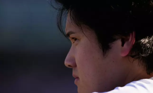 Los Angeles Dodgers' Shohei Ohtani looks on from the dugout during the eighth inning of Game 1 of a National League Division Series baseball game against the Atlanta Braves Saturday, Oct. 3, 2026, in Los Angeles. (AP Photo/Mark J. Terrill)