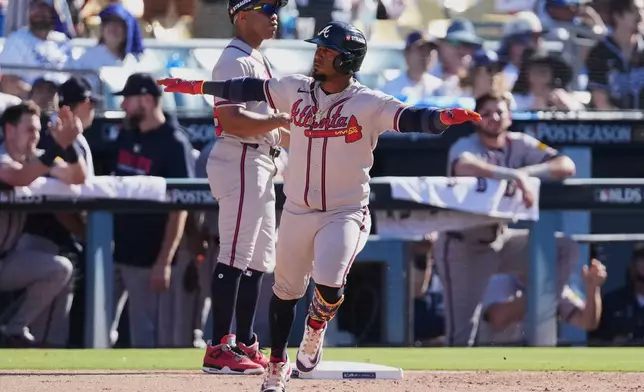 Atlanta Braves' Ozzie Albies celebrates after hitting a two-run home run during the ninth inning of Game 1 of a National League Division Series baseball game against the Los Angeles Dodgers Saturday, Oct. 3, 2026, in Los Angeles. (AP Photo/Jae C. Hong)