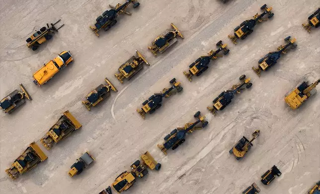 Heavy equipment and machinery intended for work on border barriers and roads are stored in a yard, Friday, Sept. 25, 2026, near Terlingua, Texas. (AP Photo/John Locher)