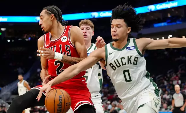Milwaukee Bucks guard Brayden Burries (0) attempts to steal the ball from Chicago Bulls guard Noa Essengue (2) during the second half of an NBA preseason basketball game, Wednesday Oct. 14, 2026, in Milwaukee. (AP Photo/Ross Harried)