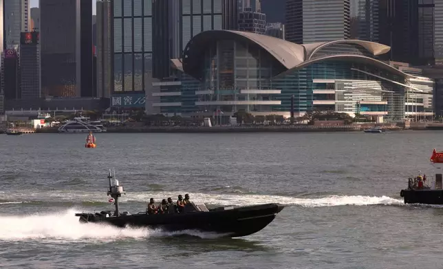 Hong Kong Marine Police vessel is seen in the foreground of the Hong Kong Convention and Exhibition Centre, the venue of the Asia-Pacific Economic Cooperation (APEC) Finance Ministers' Meeting, in Hong Kong on Tuesday, Oct. 20, 2026. (AP Photo/May James)