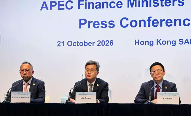 Eduardo Pedrosa, from left, executive director of the APEC Secretariat, China's Finance Minister Lan Fo'an, chair of the 2026 APEC Finance Ministers' Meeting, and China's Vice Finance Minister Liao Min hold a news conference at the Asia-Pacific Economic Cooperation (APEC) Finance Ministers' Meeting at the Hong Kong Convention and Exhibition Centre, Wednesday, Oct. 21, 2026. (AP Photo/Chan Ho-him)