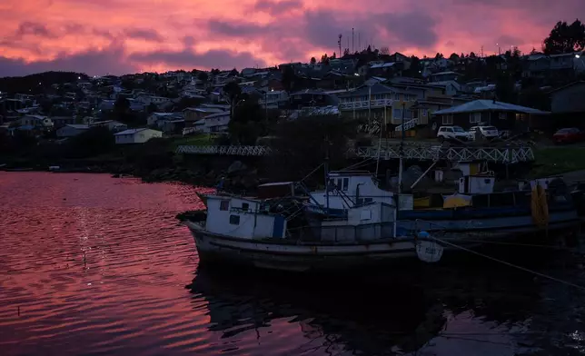 Fishing boats dock in the town of Melinka at dawn in the Guaitecas Archipelago, Chile, Thursday, May 22, 2025. (AP Photo/Adriana Thomasa)