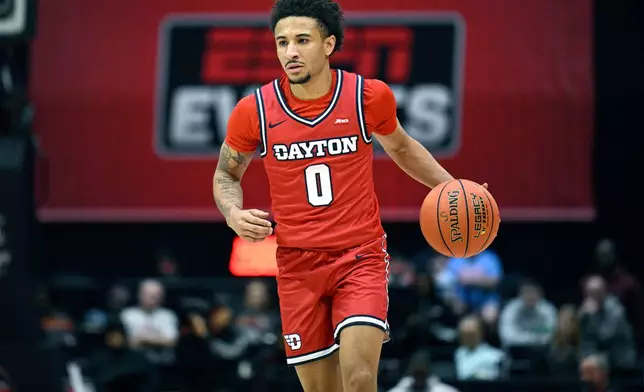 FILE - Dayton guard Javon Bennett (0), who has since transferred to Gonzaga, brings the ball up the court against BYU during the first half of an NCAA college basketball game, Friday, Nov. 28, 2025, in Kissimmee, Fla. (AP Photo/Phelan M. Ebenhack, File)